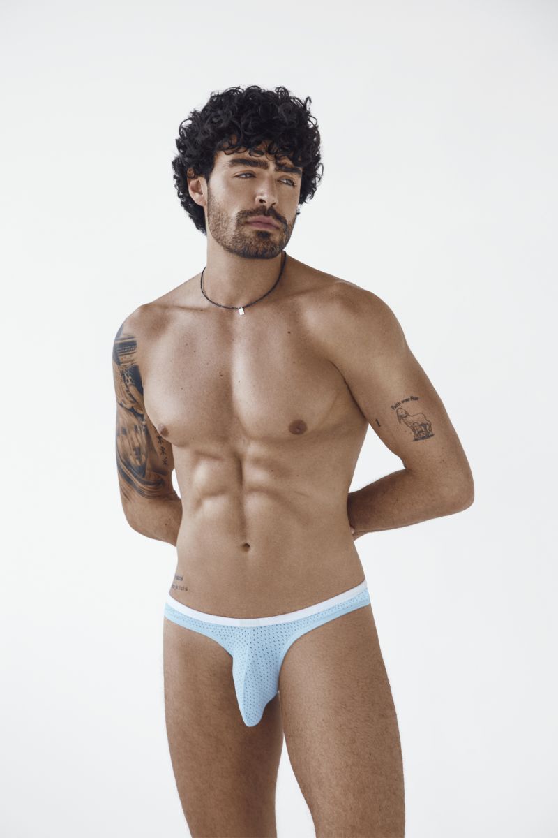 A model wears light blue Ulises briefs with a perforated texture and white waistband against a white background.