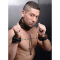 Black leather coax collar with brass hardware and matching wrist cuffs linked by a chain restraint set