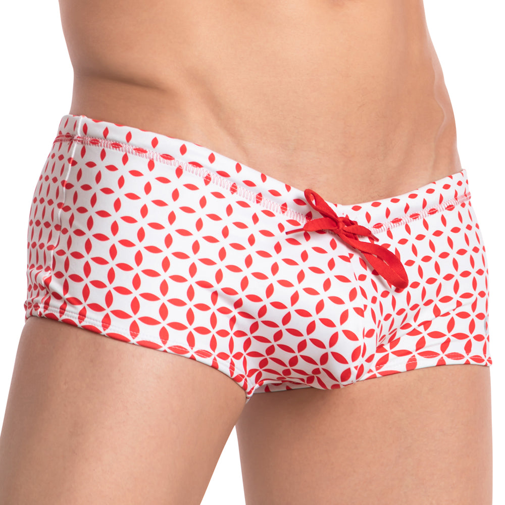 White swim trunks with red geometric leaf pattern and red drawstring from cover male cmh008 swimwear collection