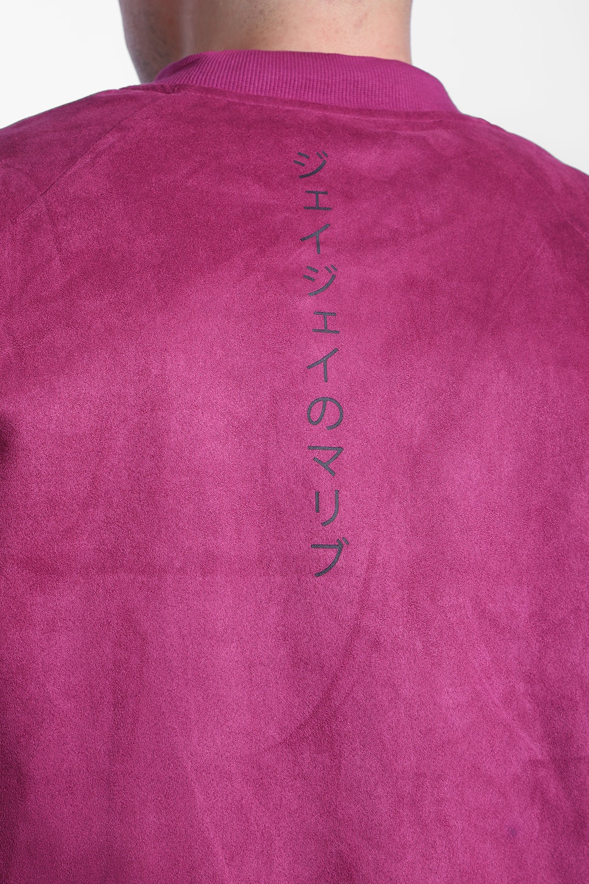 Cropped magenta suede bomber jacket with vertical black Japanese text on the back side