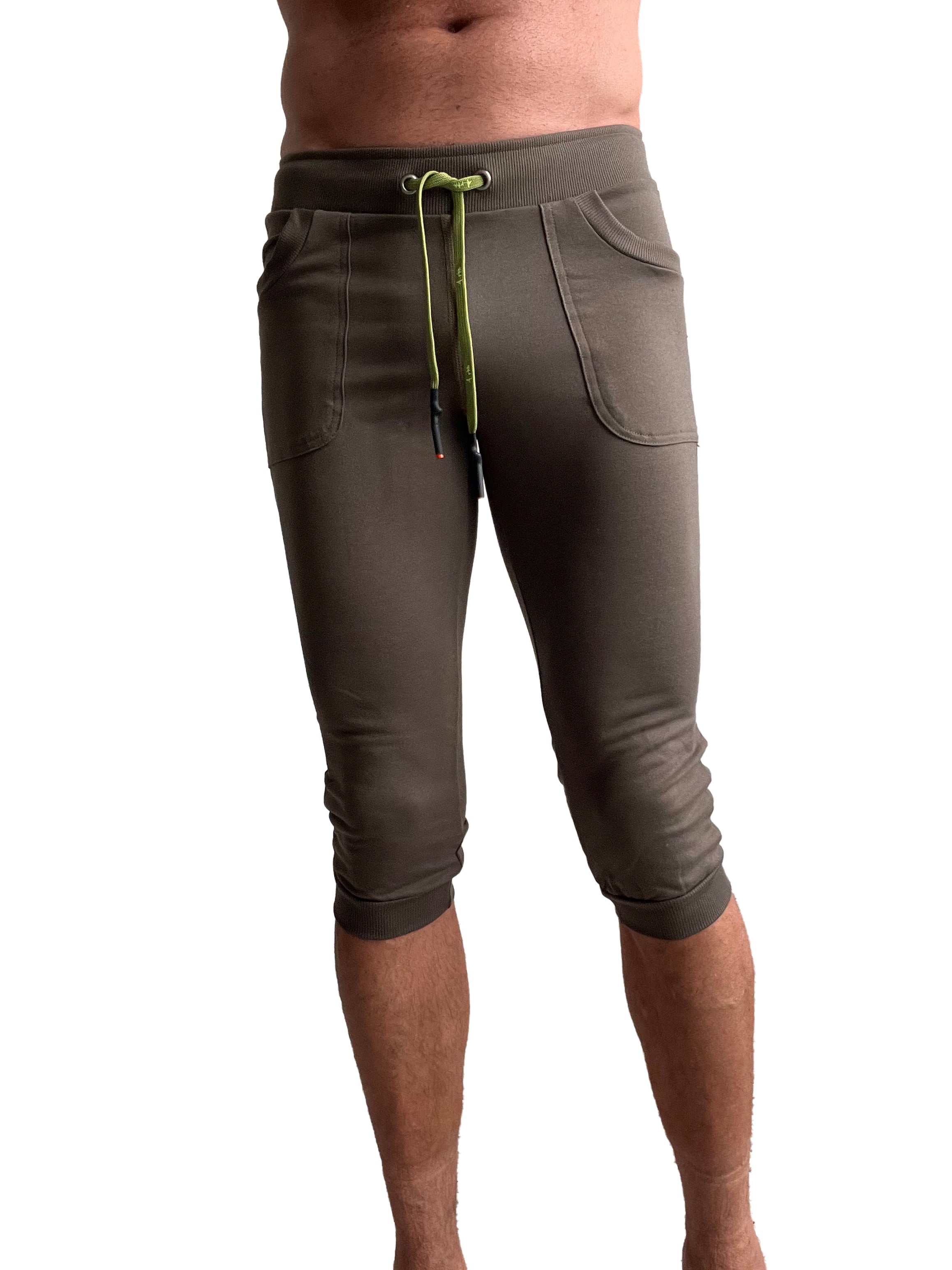Olive green cuffed yoga pants in capri length with lime green drawstring and side pockets for comfortable wear