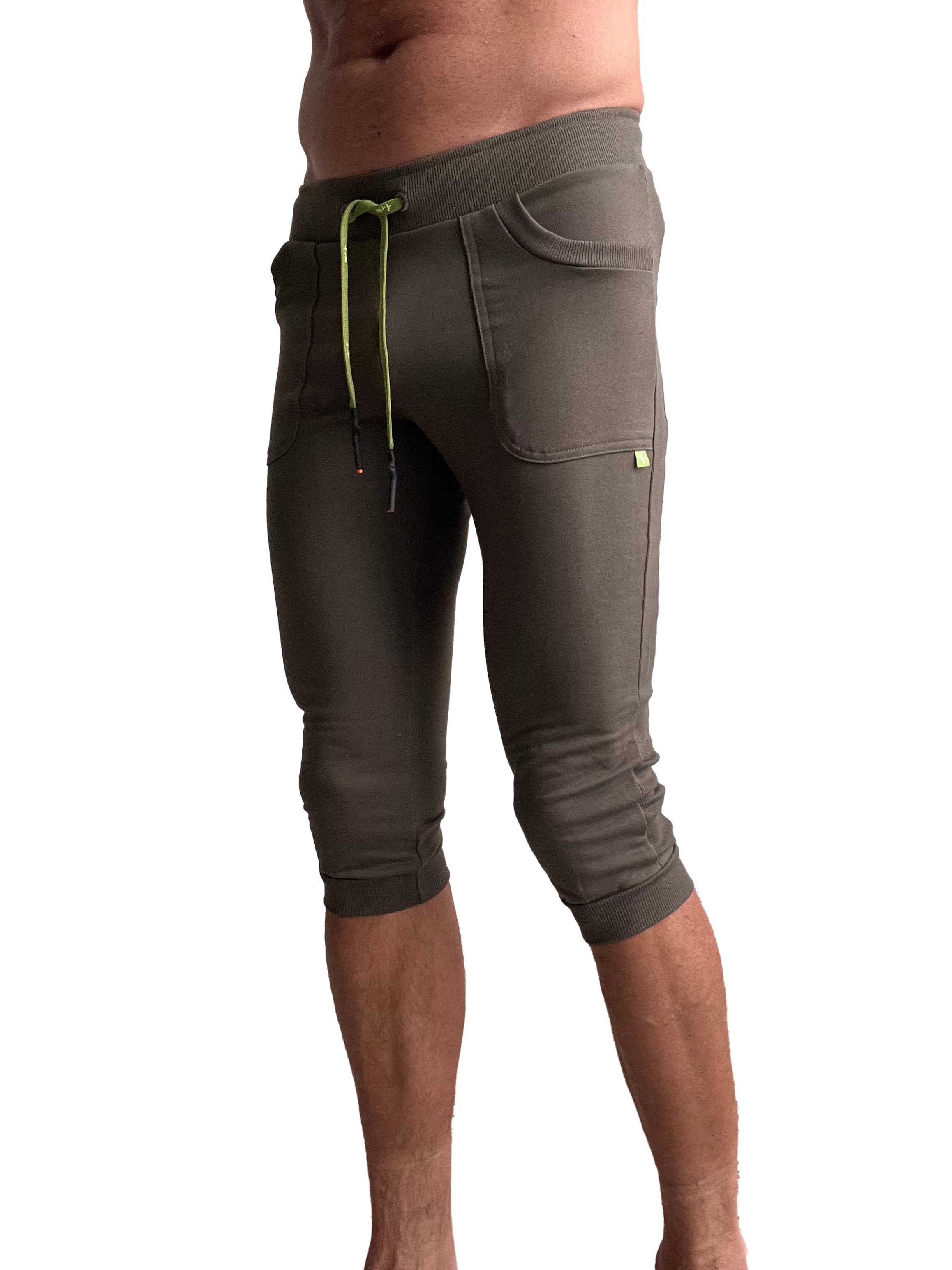 Olive green cuffed yoga pants with ribbed waistband lime green drawstring and capri-length jogger style