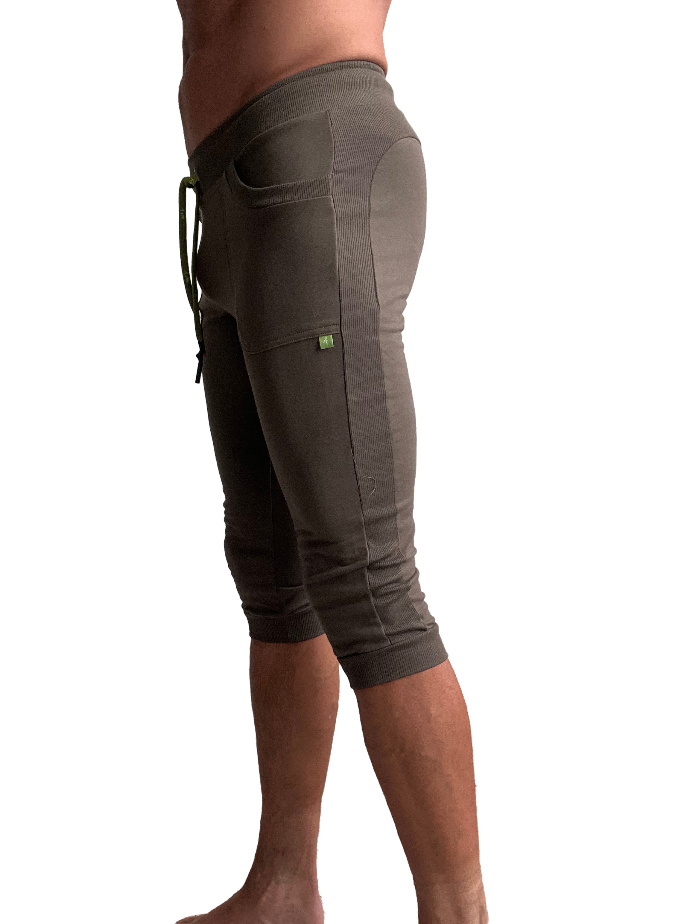 Olive green ribbed knit cuffed yoga capri pants with side pockets and drawstring waistband for activewear