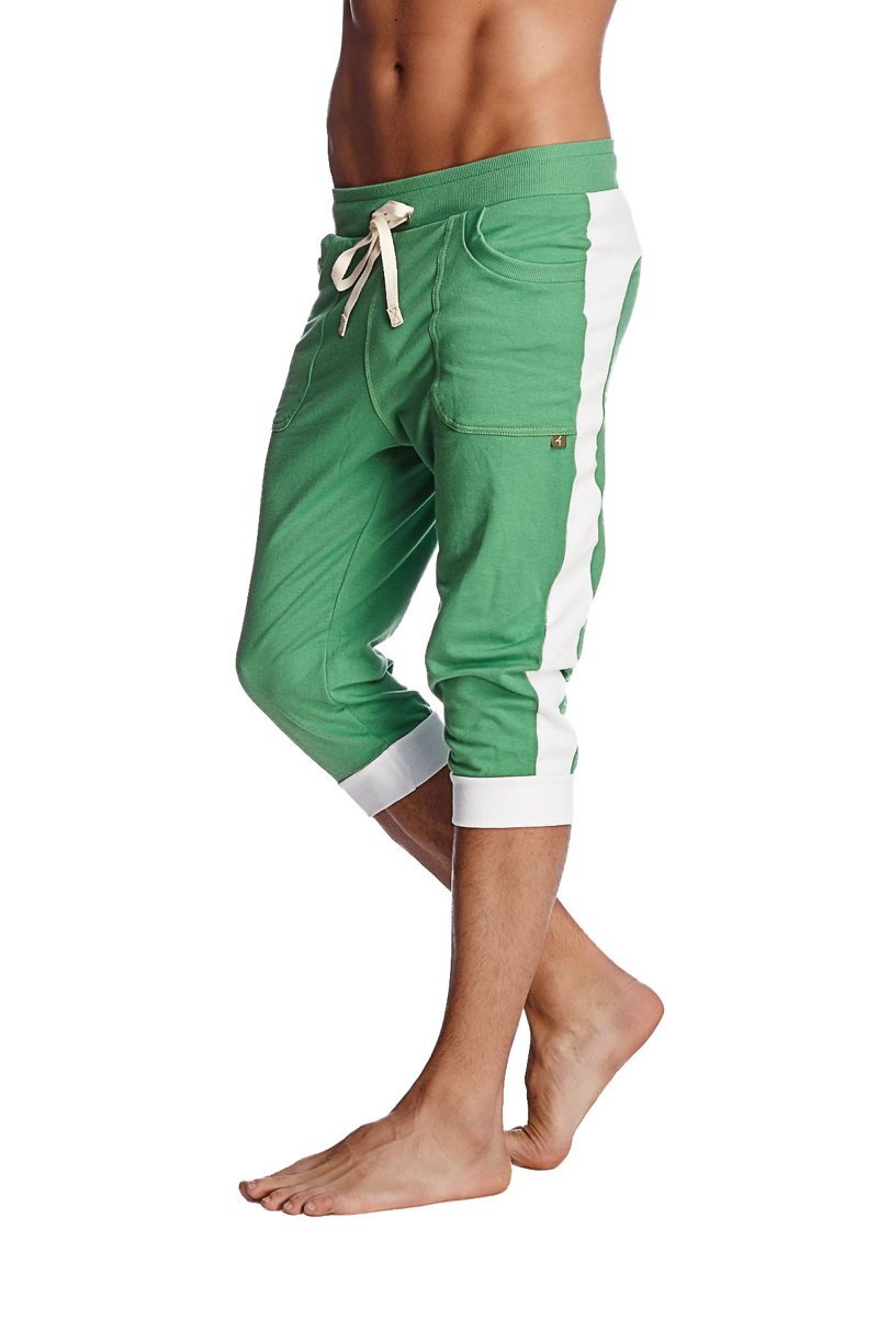 Green cuffed yoga pants in bamboo green with white side stripes and drawstring waistband for comfortable wear