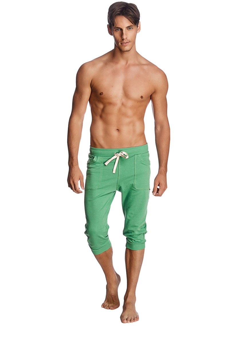 Green cuffed yoga pants in bamboo fabric with white drawstring and side pockets for comfortable wear
