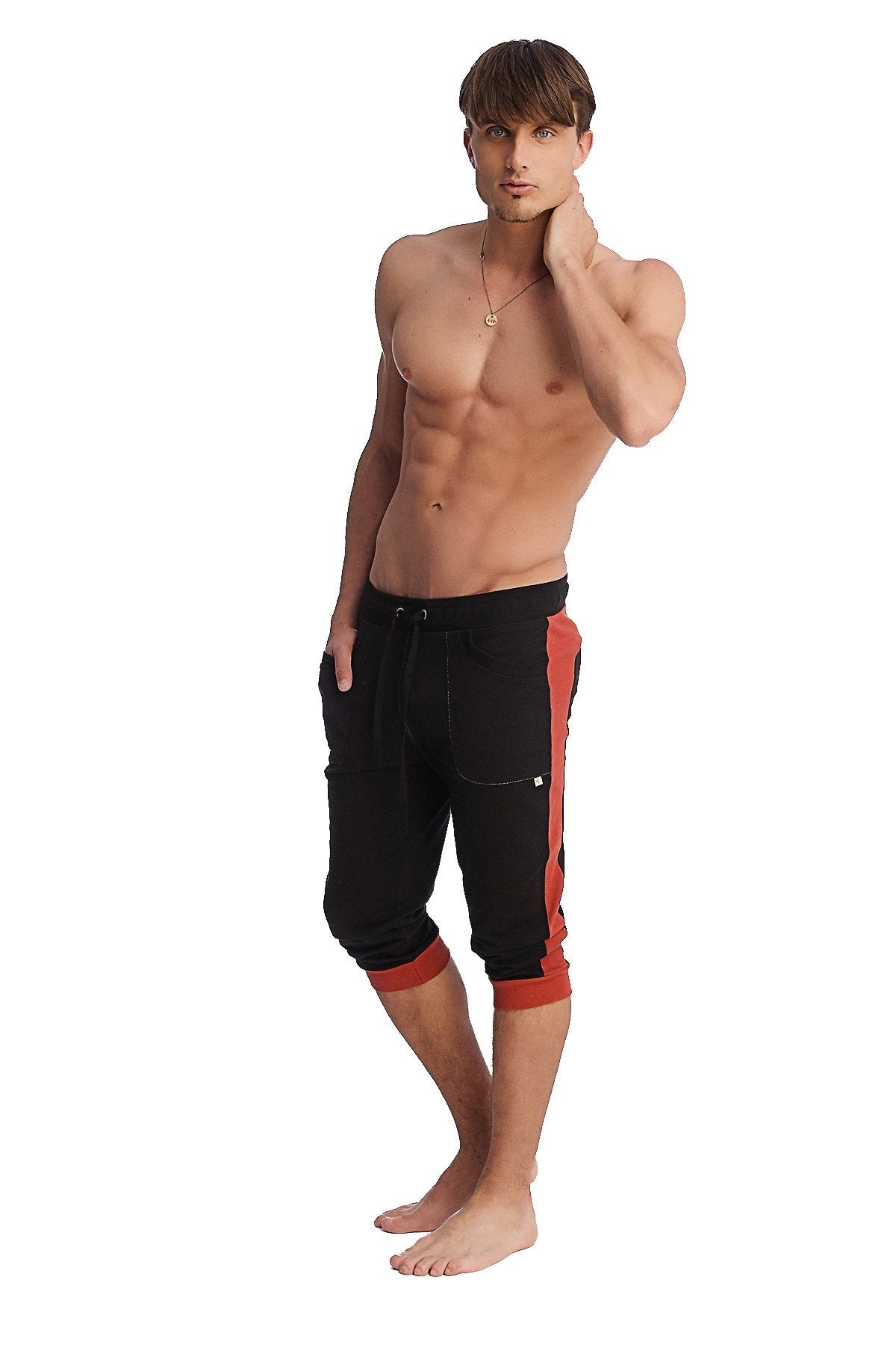 Black cuffed yoga pants with bold cinnabar red side stripes and matching red cuffs for active wear