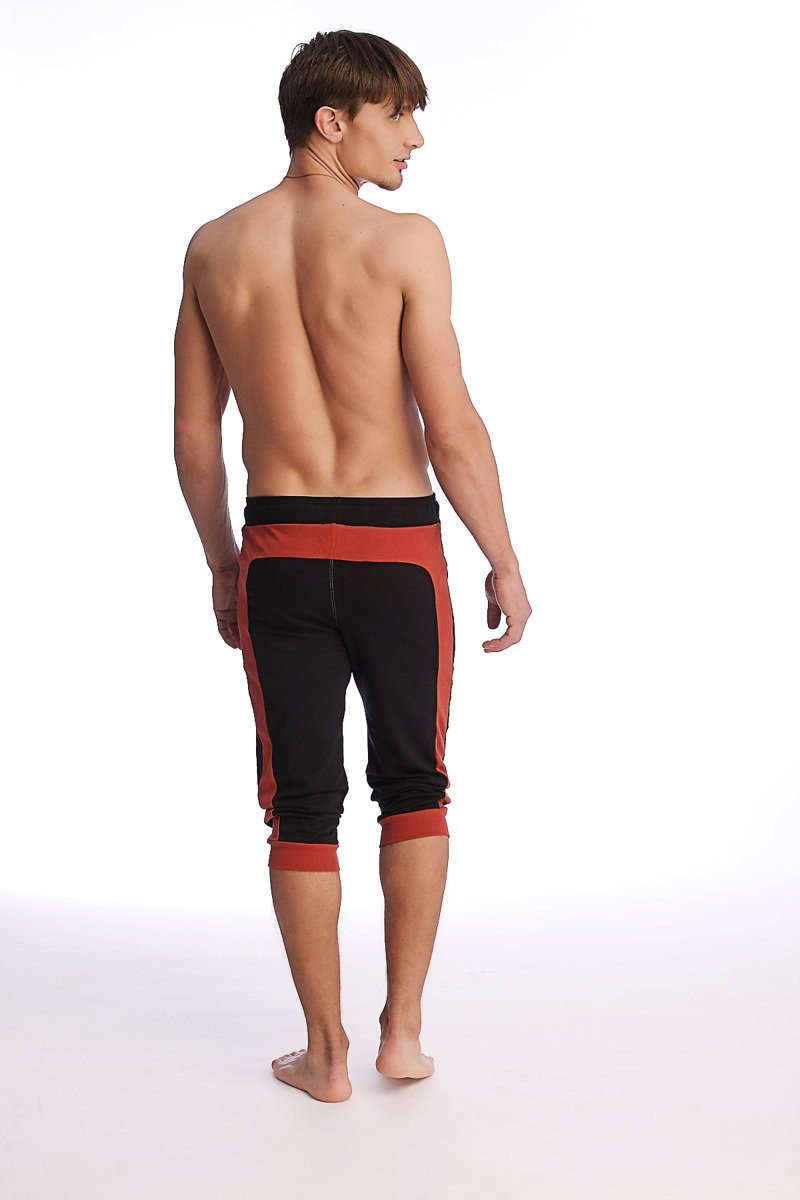 Black and cinnabar cuffed yoga pants with elastic waistband and ribbed cuffs for athletic wear