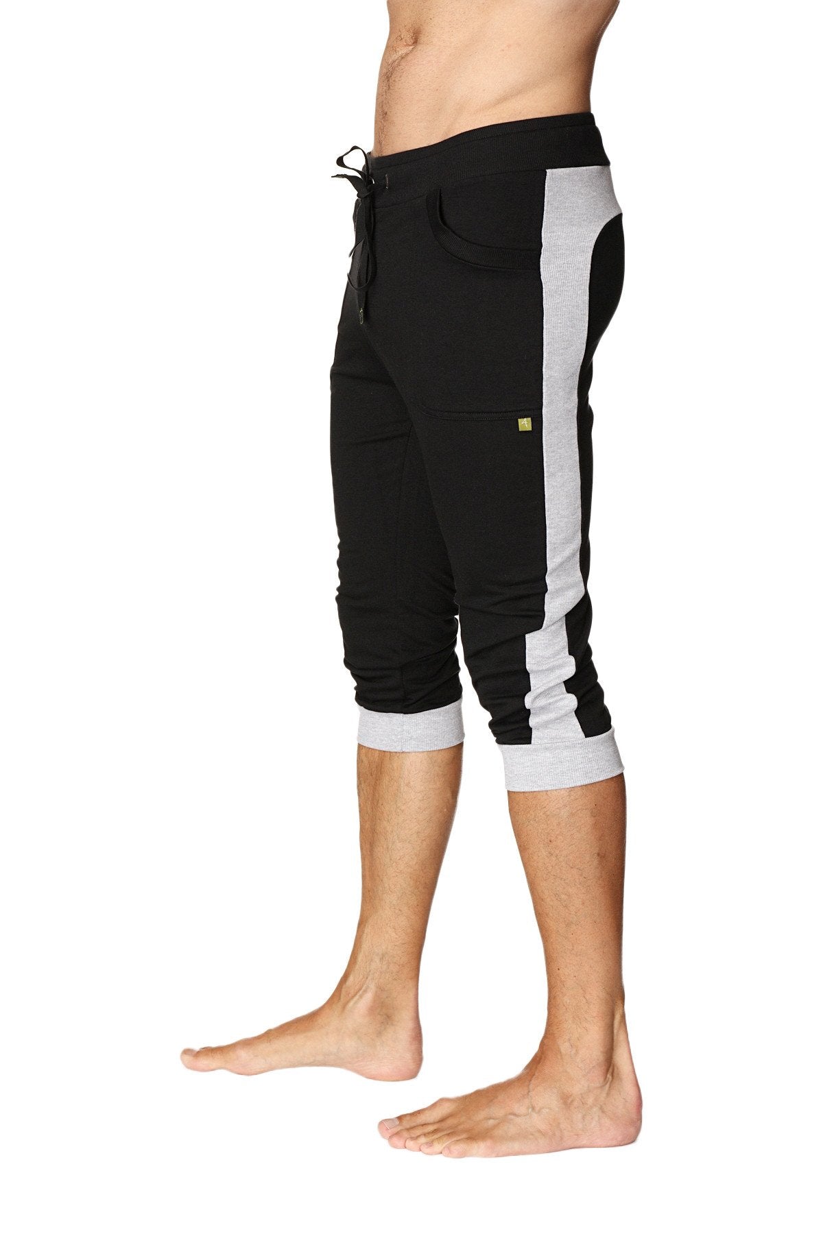Black and gray cuffed yoga pants with drawstring waist side stripes and rolled cuffs for athletic wear