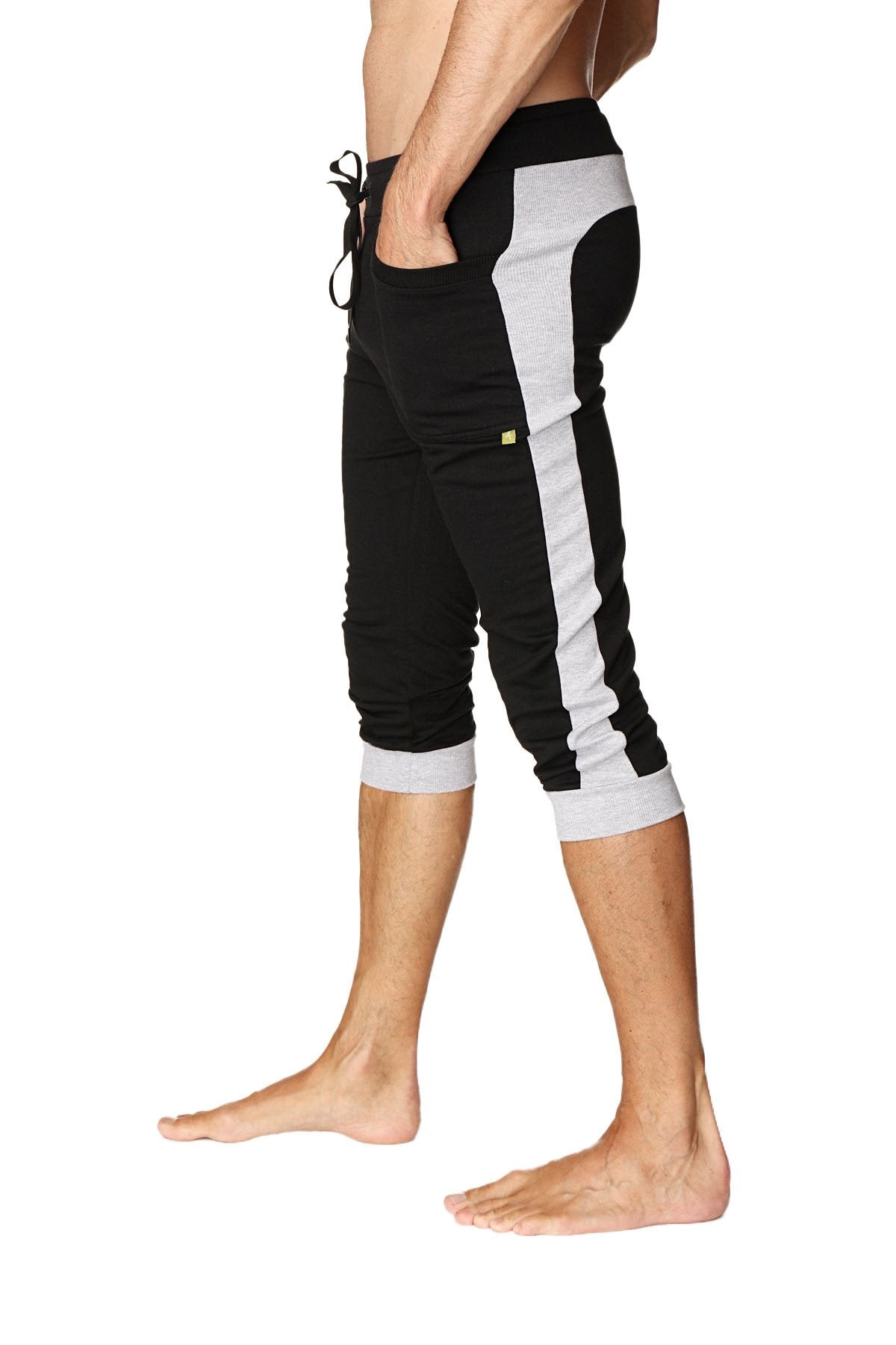 Black and gray cuffed yoga pants with side stripe elastic waistband and rolled cuffs for athletic wear