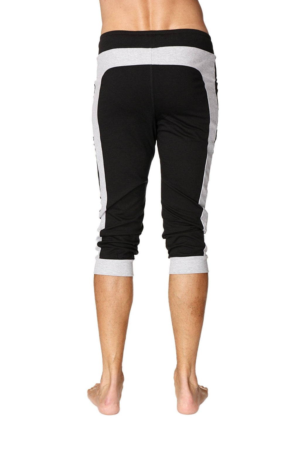 Black and gray cuffed yoga pants with ribbed waistband side panels and rolled cuffs for athletic wear