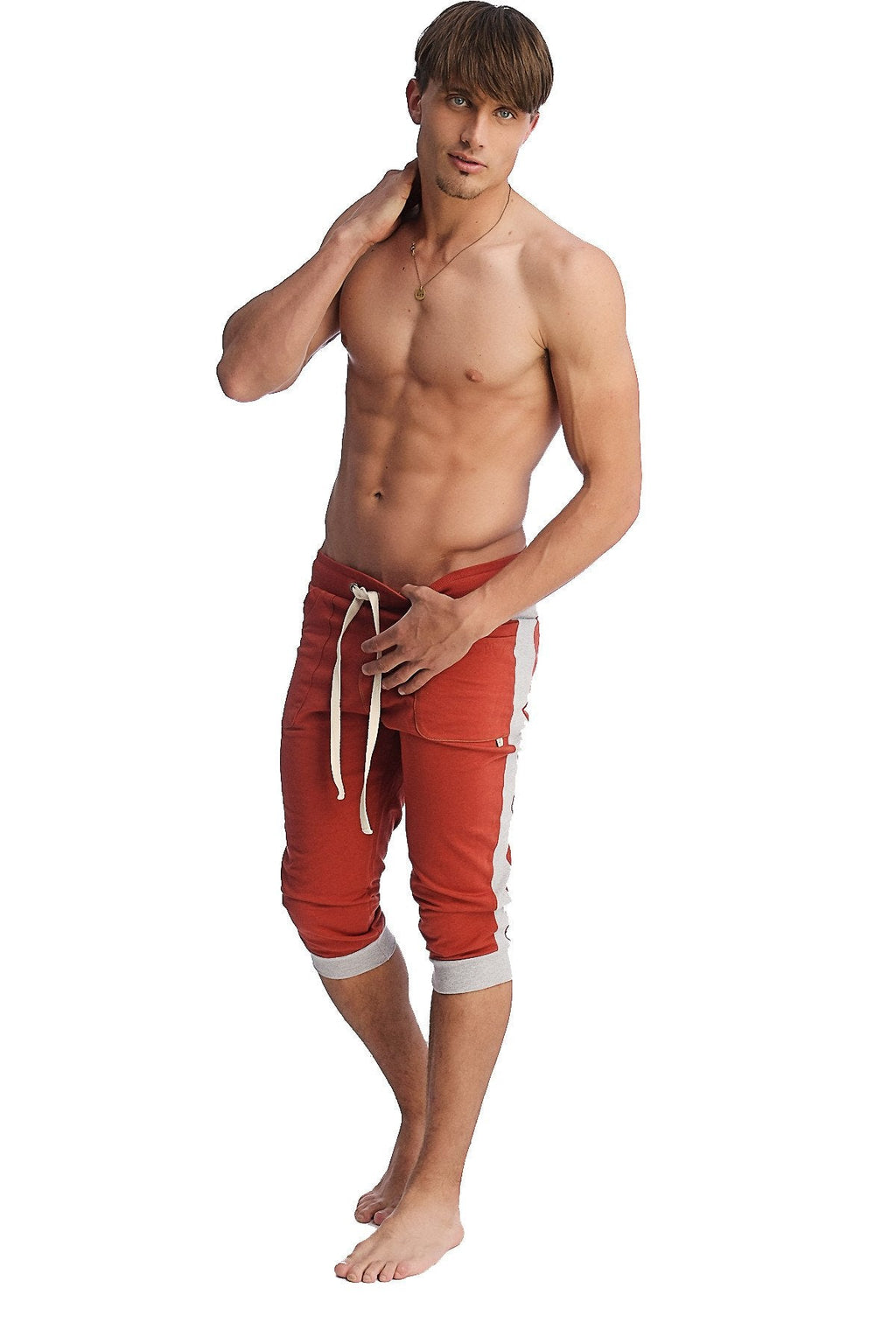 Red athletic shorts with white side stripes and matching drawstring designed for active wear and comfort