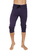 Navy blue cuffed yoga pants with black drawstring waistband and rolled cuffs in capri-length style