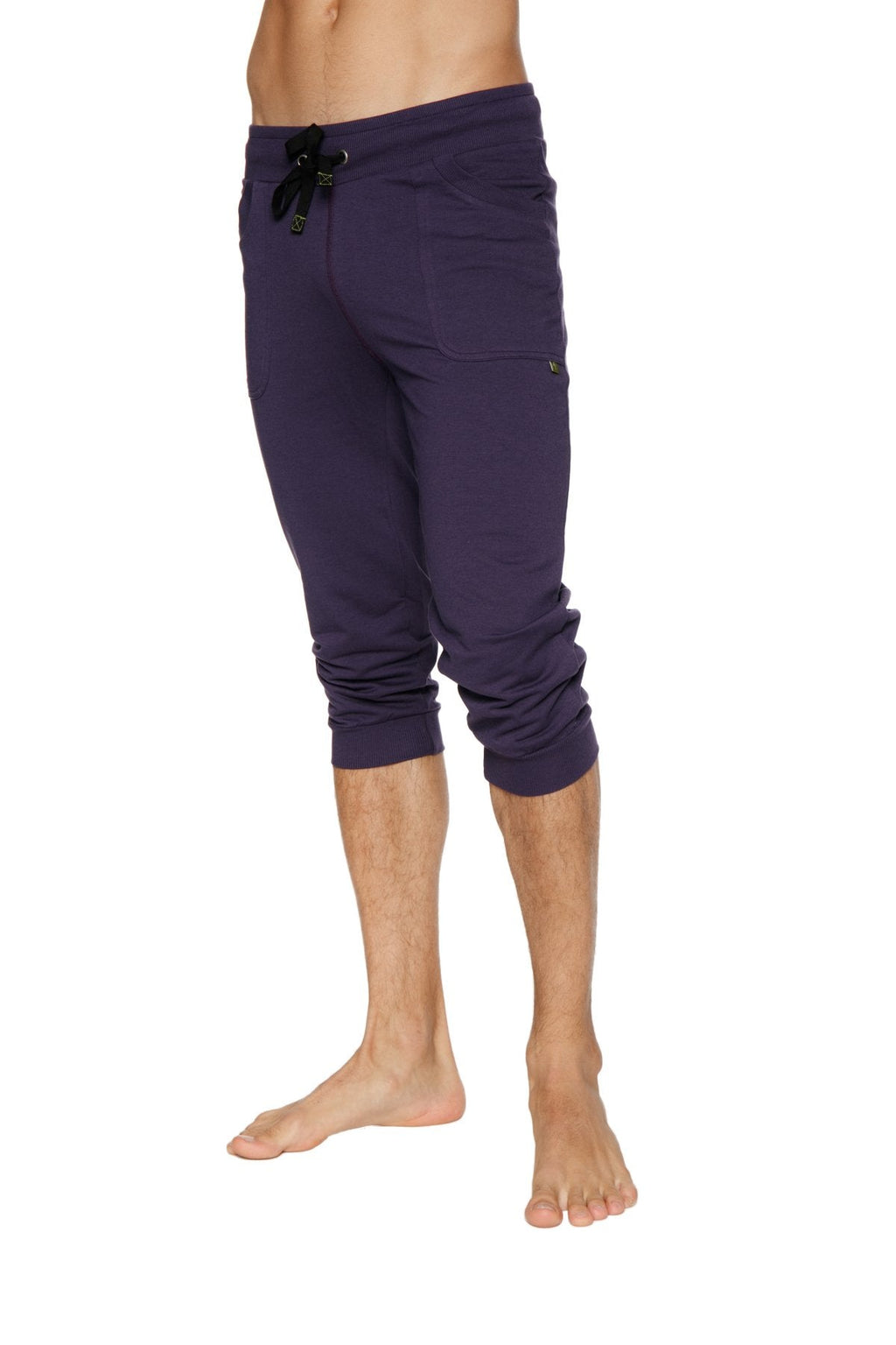 Purple cuffed yoga pants with black drawstring waistband and side pockets in capri-length style