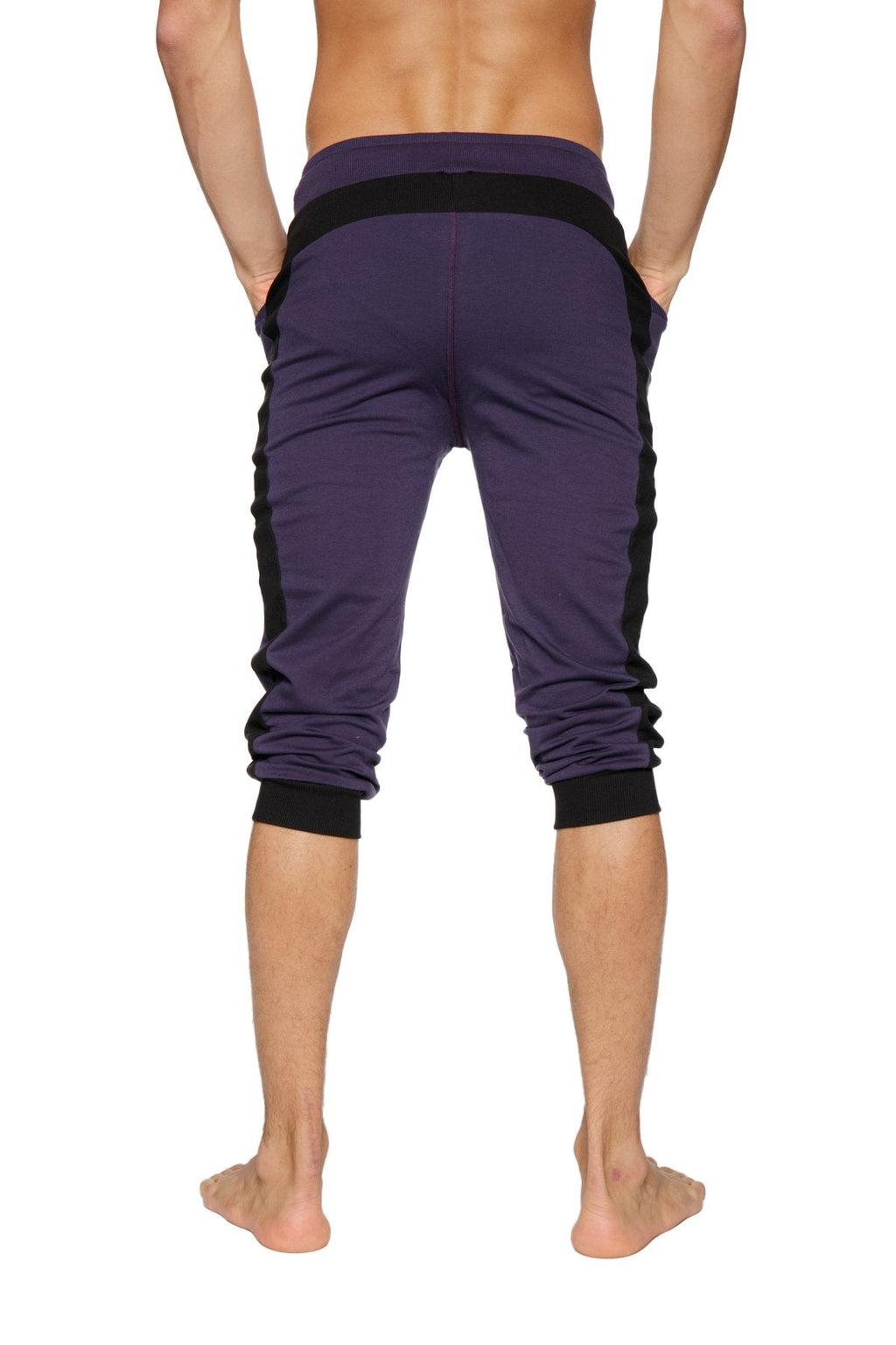 Purple cuffed yoga pants with black side panels and elastic cuffs made for athletic wear