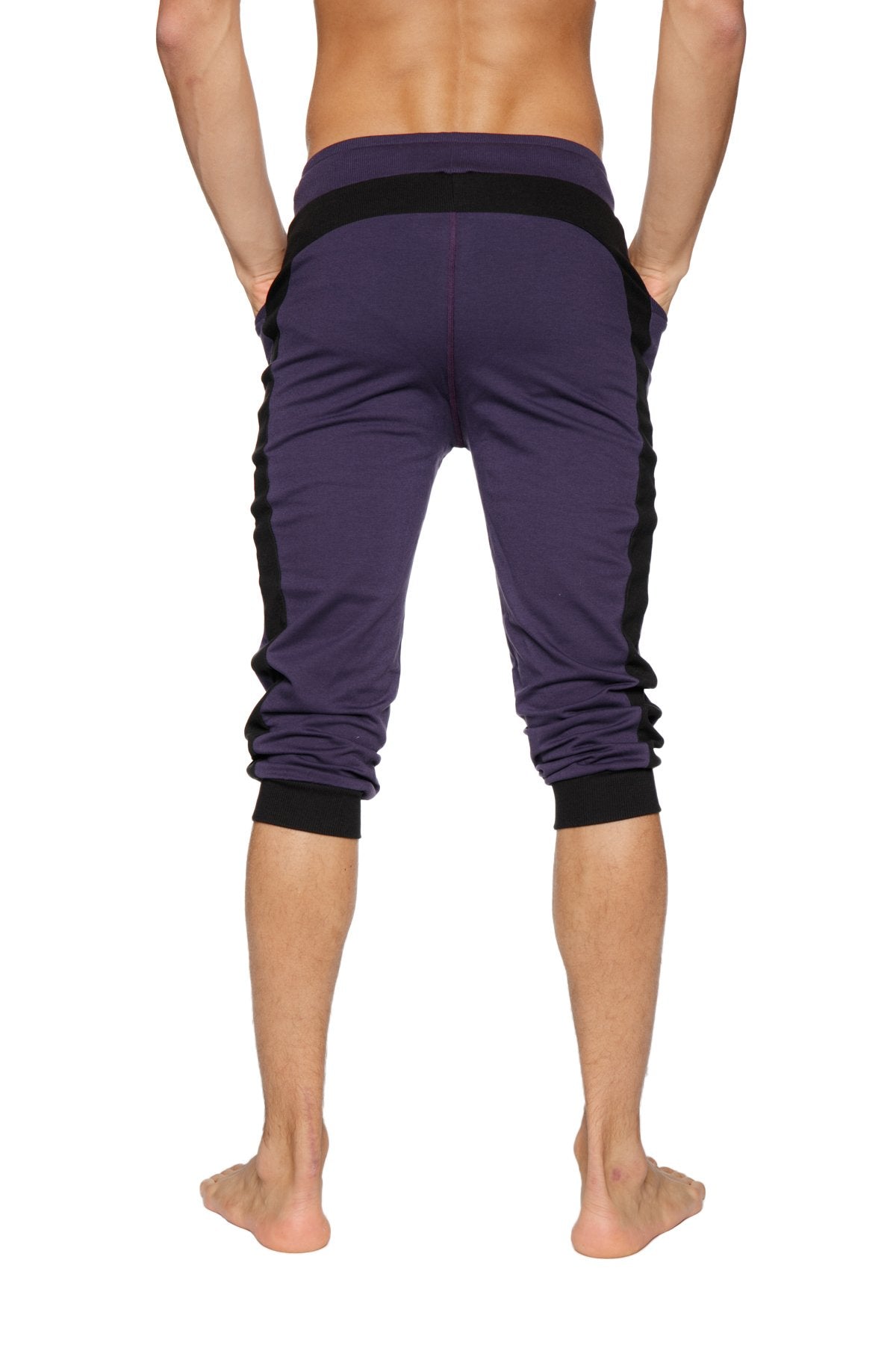 Purple cuffed yoga pants with black side panels and elastic cuffs made for athletic wear