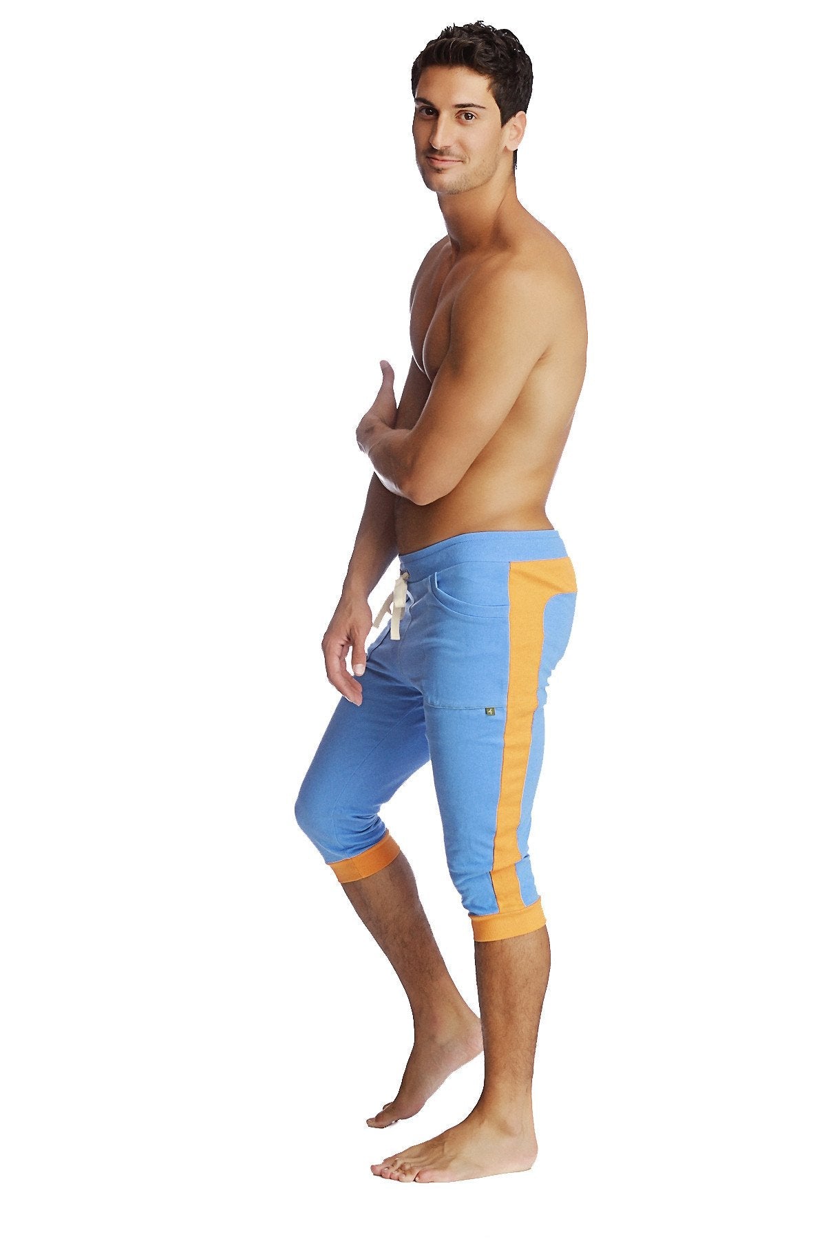 Cuffed yoga pants in ice blue with orange featuring a drawstring waistband and athletic capri fit