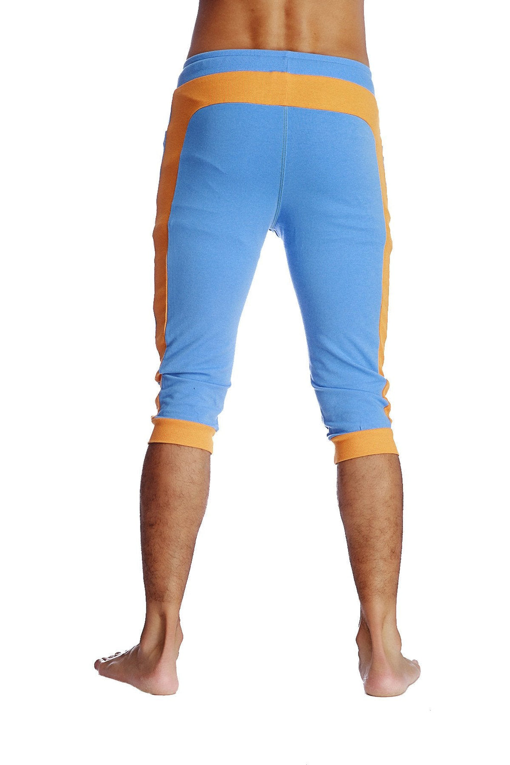 Cuffed yoga pants in ice blue with orange featuring ribbed waistband and cuffs in capri-length athletic design