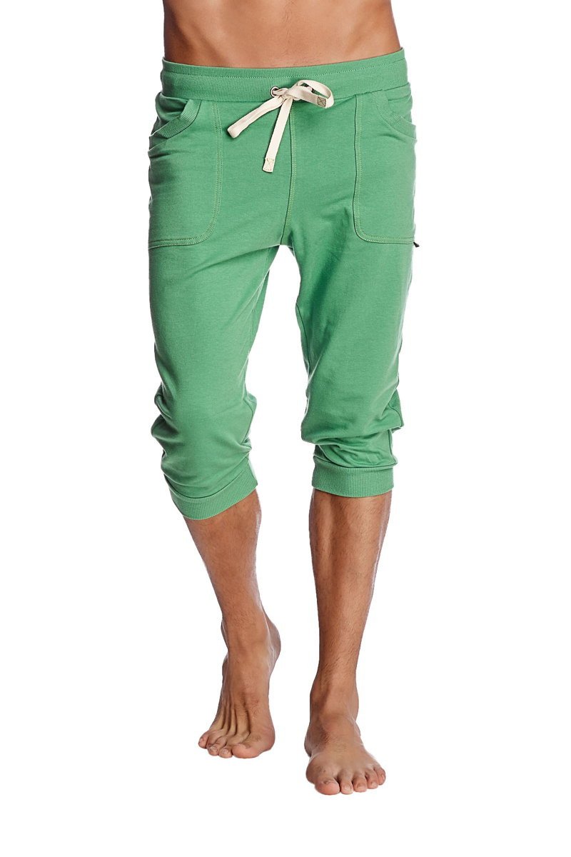 Green cuffed yoga pants in solid bamboo fabric with cream drawstring and side pockets in capri length
