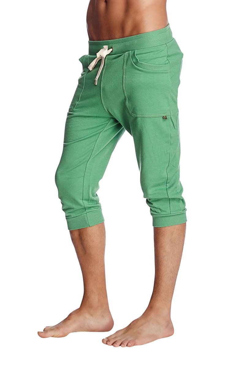 Green cuffed yoga pants in solid bamboo green with drawstring waistband and side pockets for comfortable wear