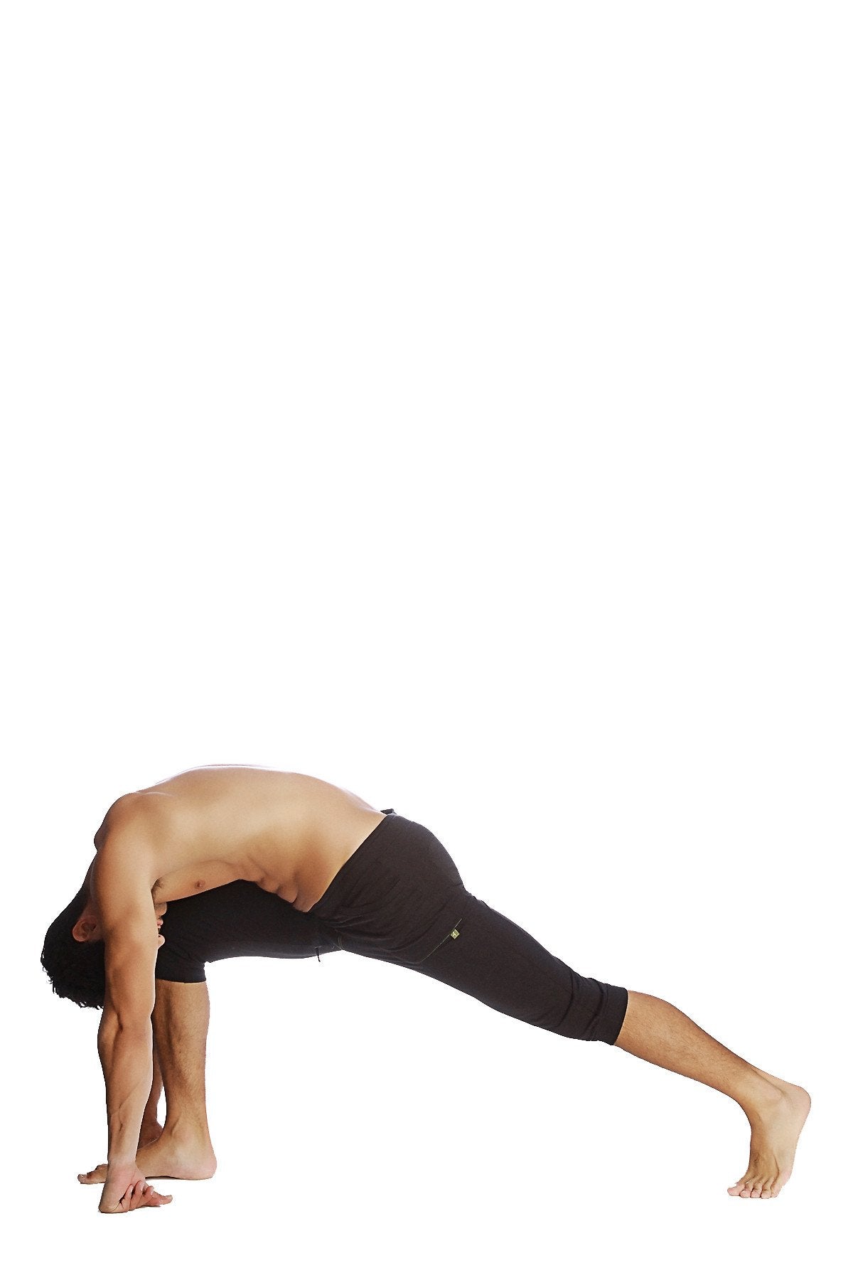 A man wearing solid black cuffed yoga pants in a yoga pose against a white background