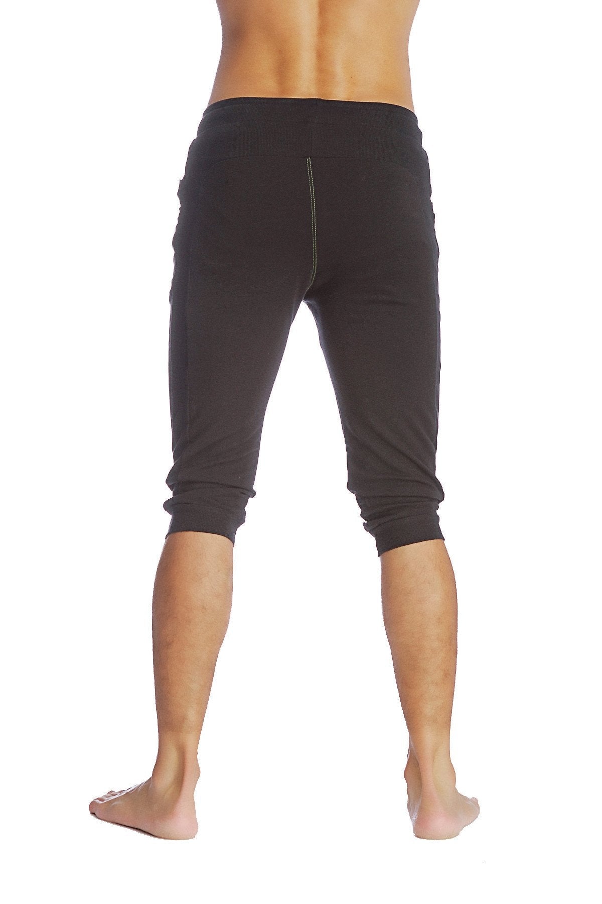 Black cuffed yoga pants with a snug fit elastic waistband and capri-length design for athletic wear