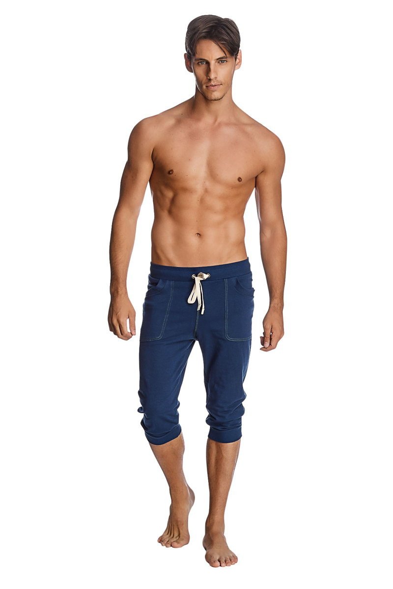 Navy blue cuffed yoga pants in capri length with white drawstring and side pockets for comfortable wear