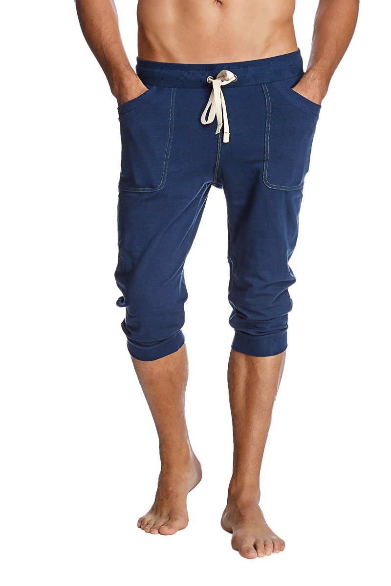 Navy blue cuffed yoga pants with white drawstring and side pockets made of comfortable fabric for active wear