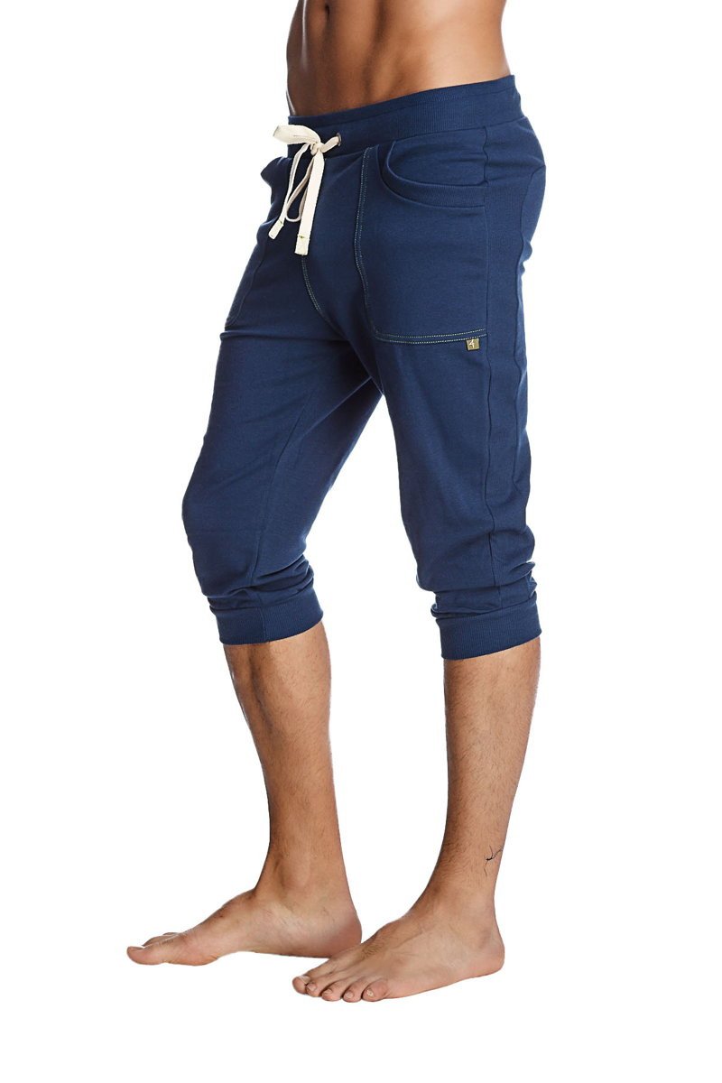 Navy blue cropped jogger pants with white drawstring and side pockets designed as cuffed yoga pants in solid royal blue