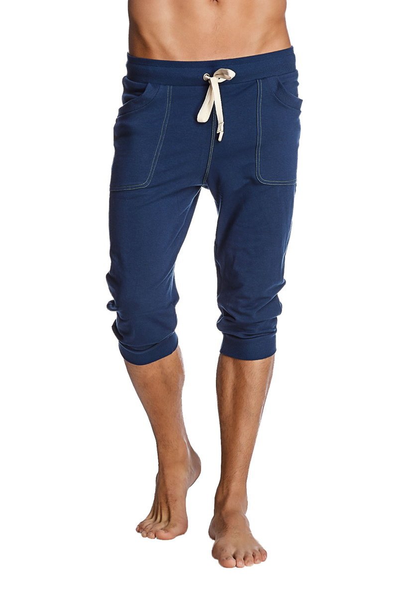 Cuffed yoga pants in solid royal blue with white drawstring and stitched pockets made from navy blue fabric