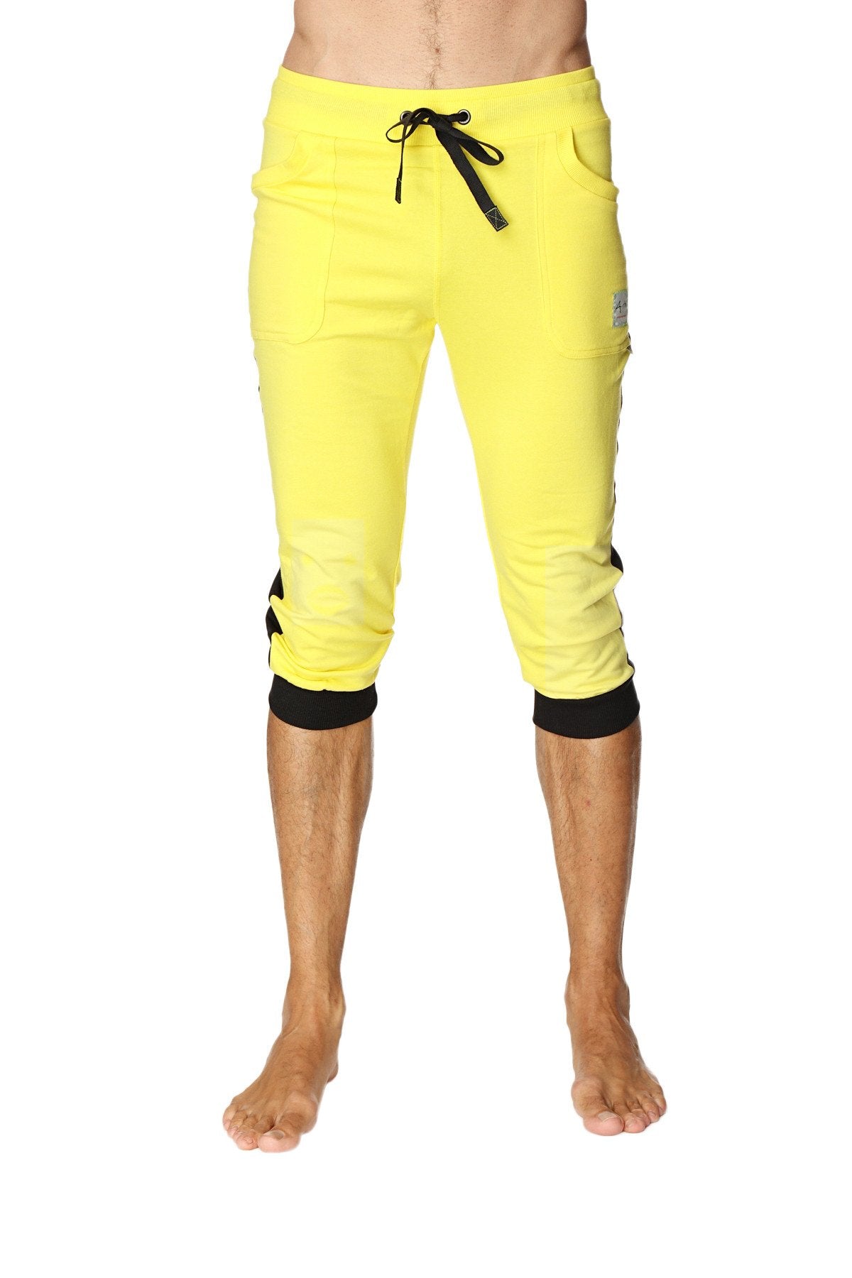 Bright yellow cuffed yoga pants with black drawstring waistband elastic cuffs and subtle side pockets
