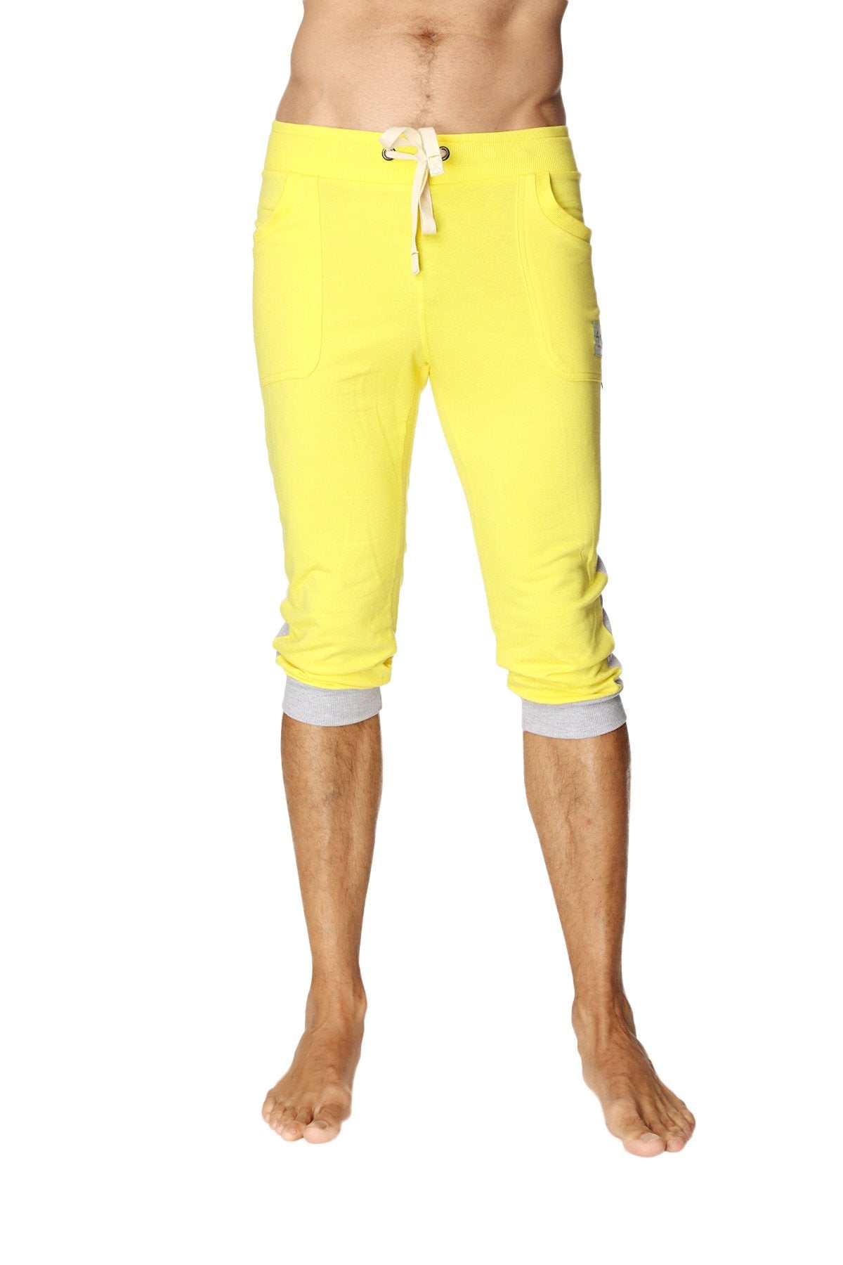 Bright yellow cuffed yoga pants with white drawstring gray elastic cuffs capri length for comfortable workouts