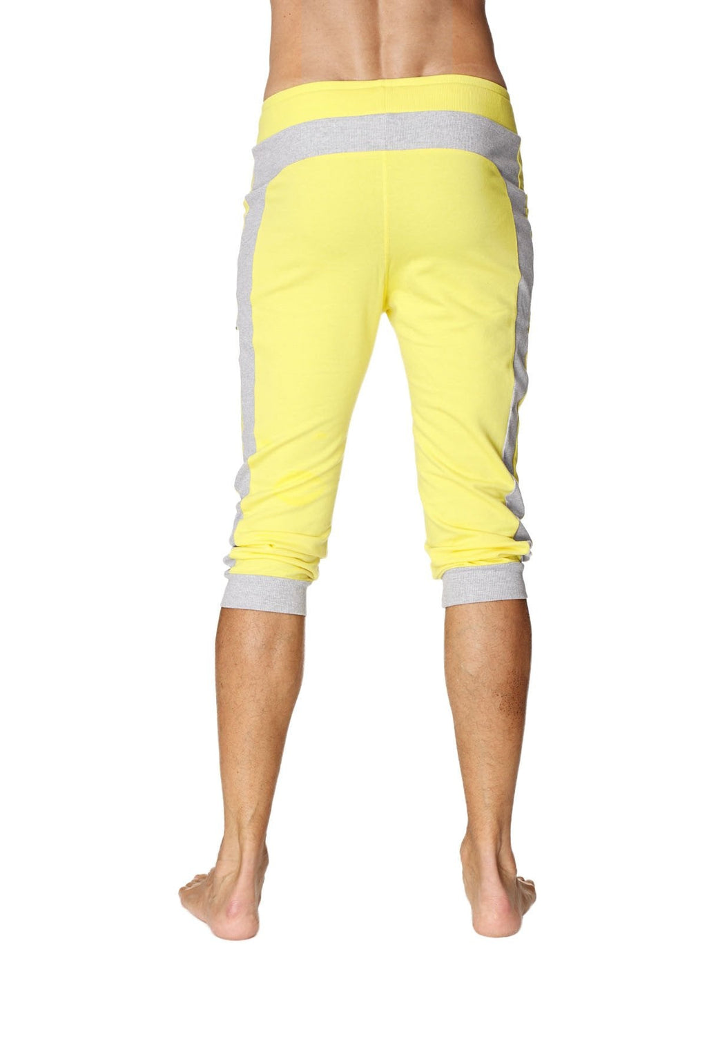 Bright yellow cuffed yoga capri pants with gray side panels and elastic cuffs for comfortable activewear