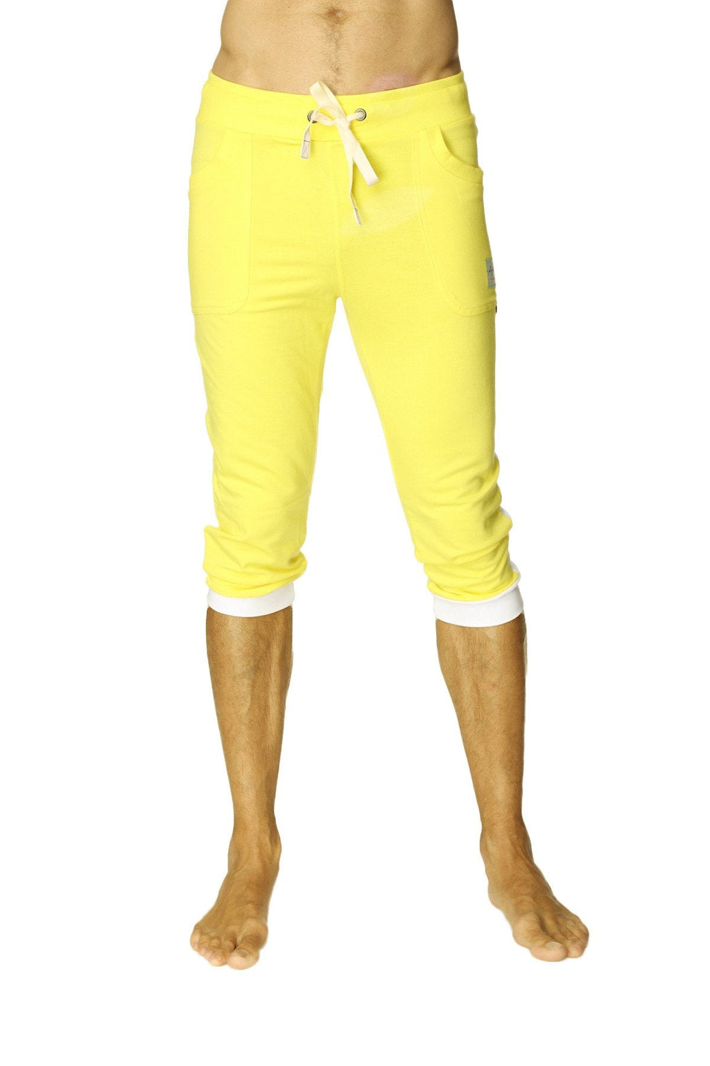 Bright yellow cuffed yoga pants with white drawstring and contrasting white cuffs in capri length for activewear