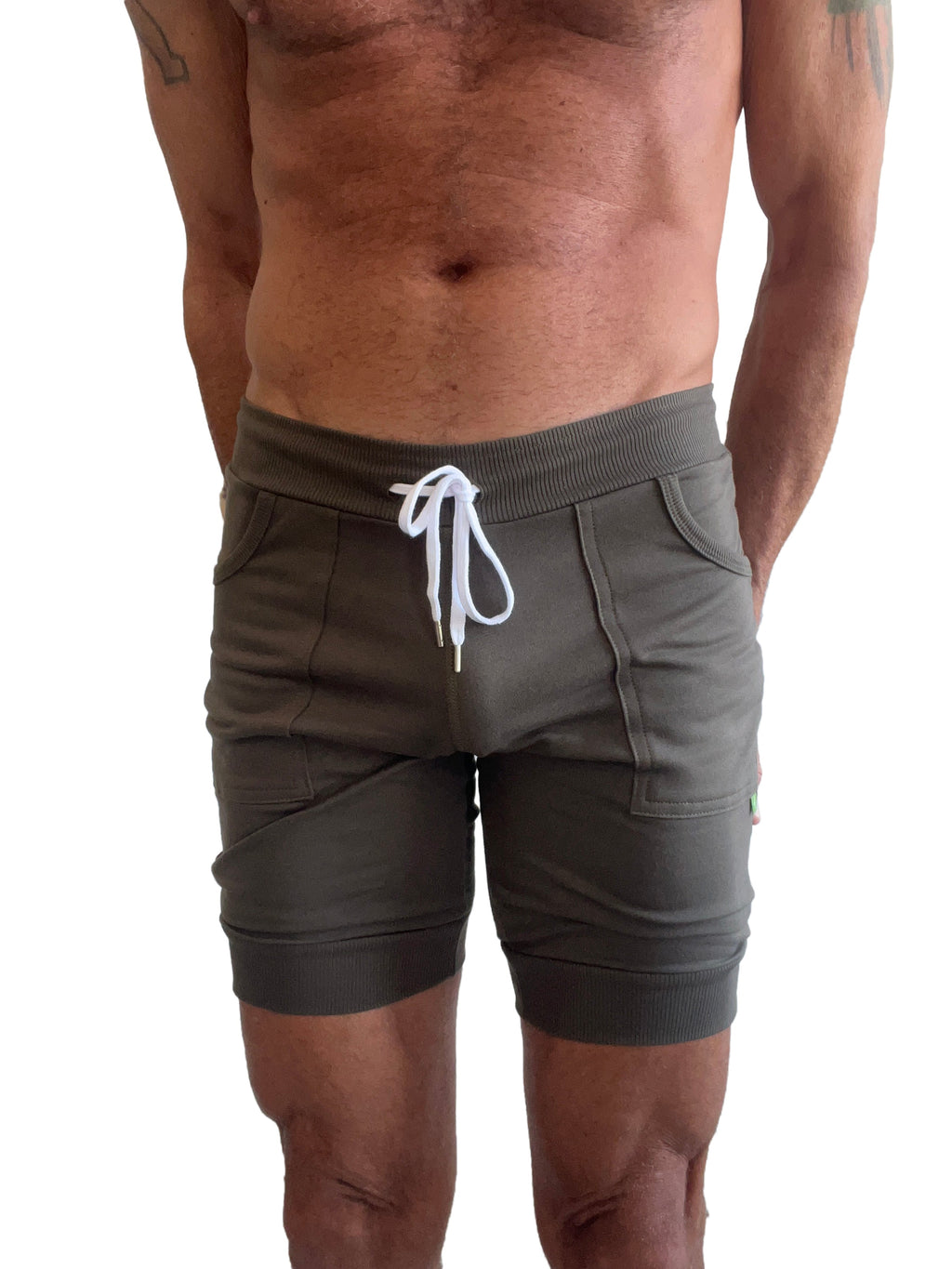 Olive green cuffed yoga shorts with white drawstring and ribbed waistband for comfortable athletic wear