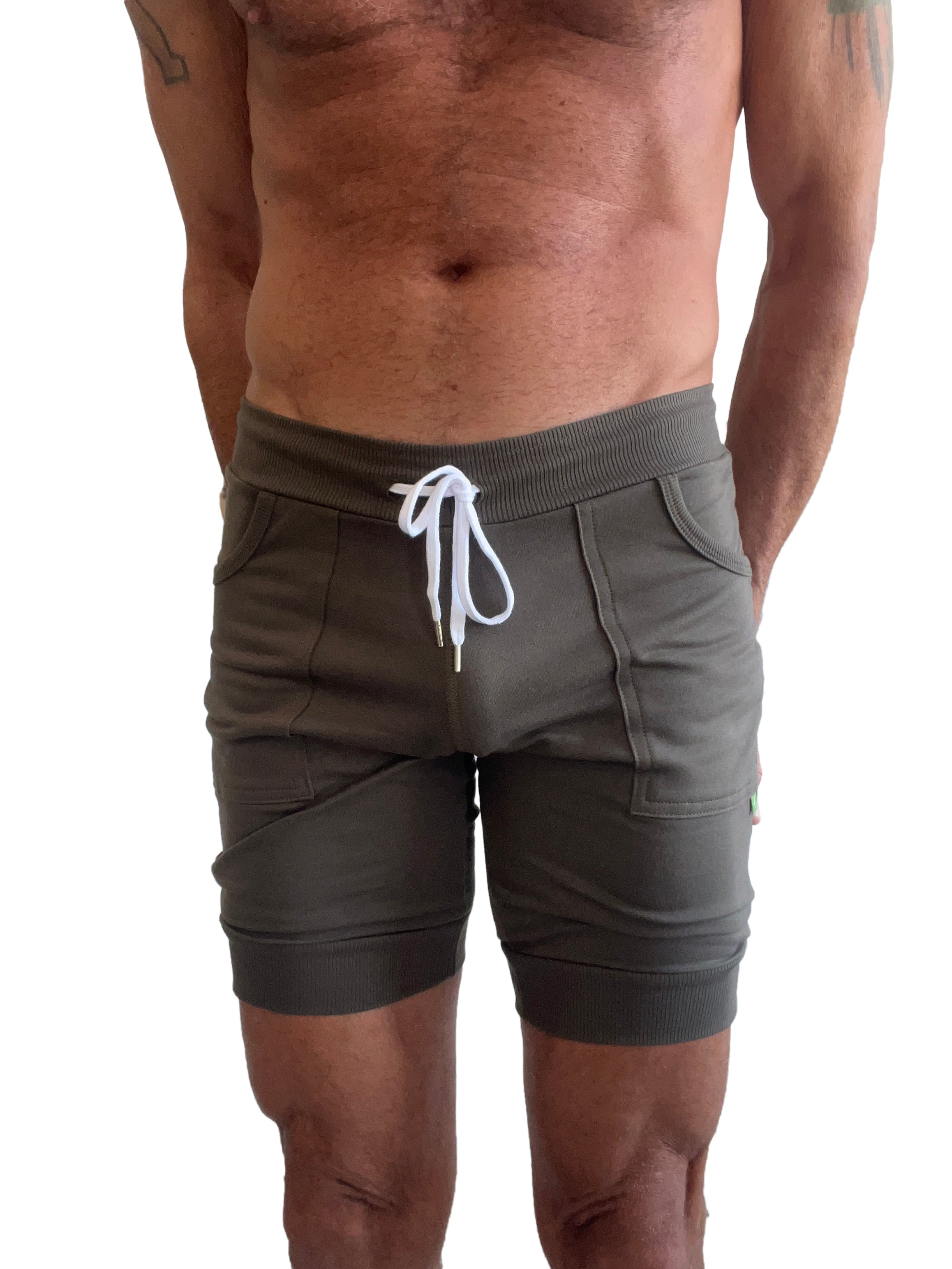 Olive green cuffed yoga shorts with white drawstring and ribbed waistband for comfortable athletic wear