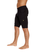 Black cuffed yoga shorts made of cotton with a white drawstring and small green logo on the side