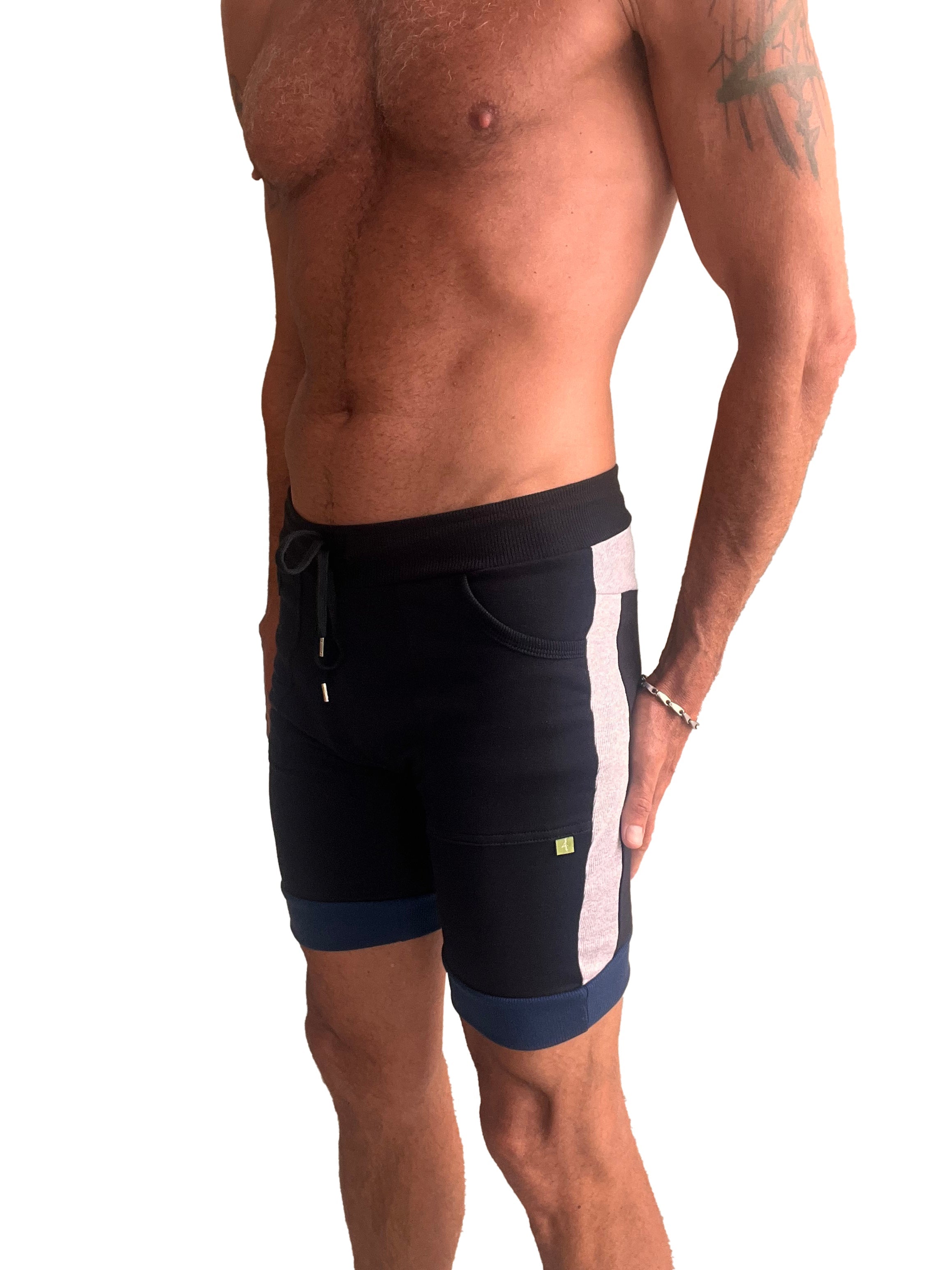 Black cuffed yoga shorts with white vertical stripe navy trim drawstring waistband and side pockets for athletic use