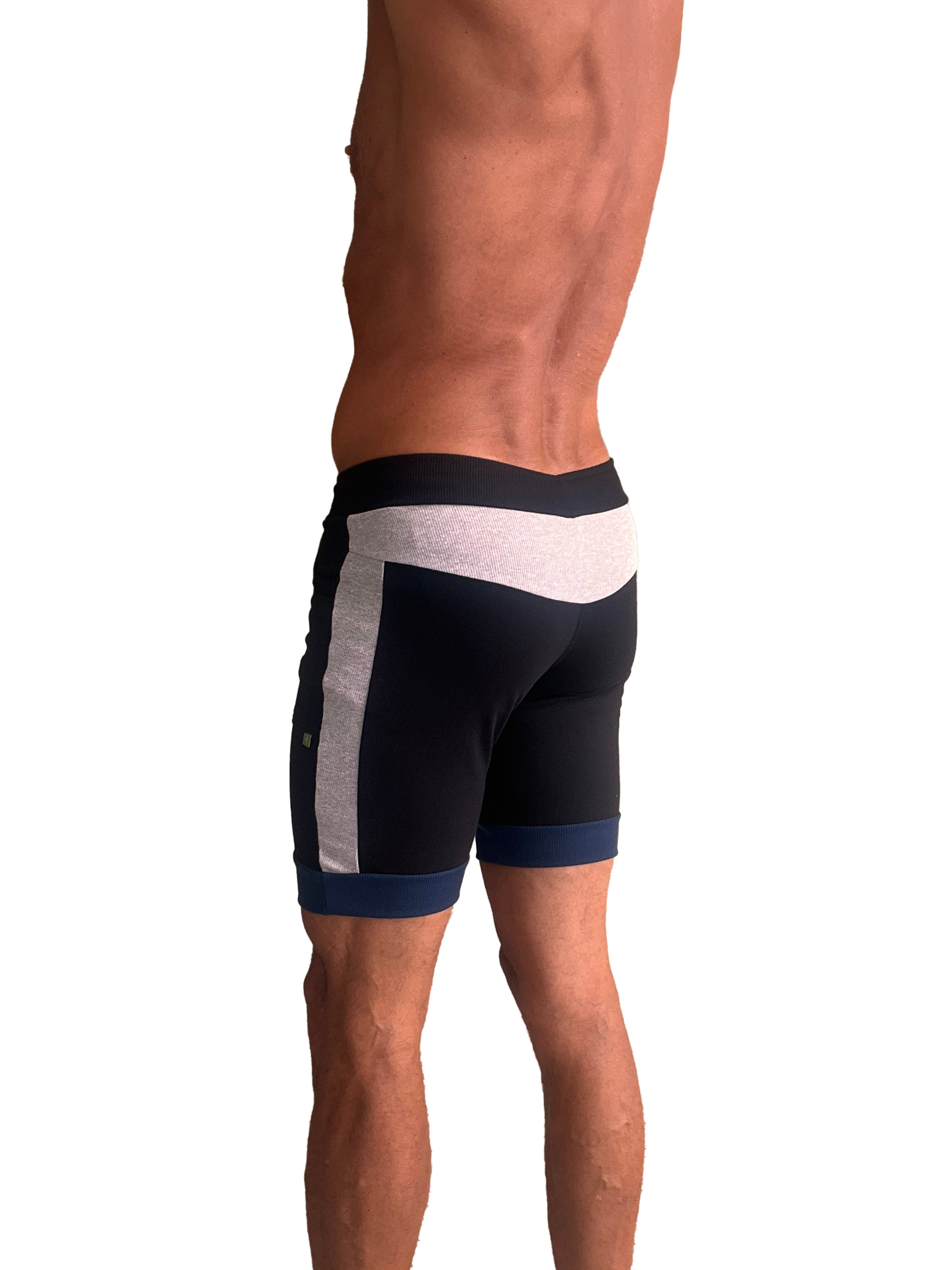 Black cuffed yoga shorts with white and gray side panels and navy blue trim at waistband and hem