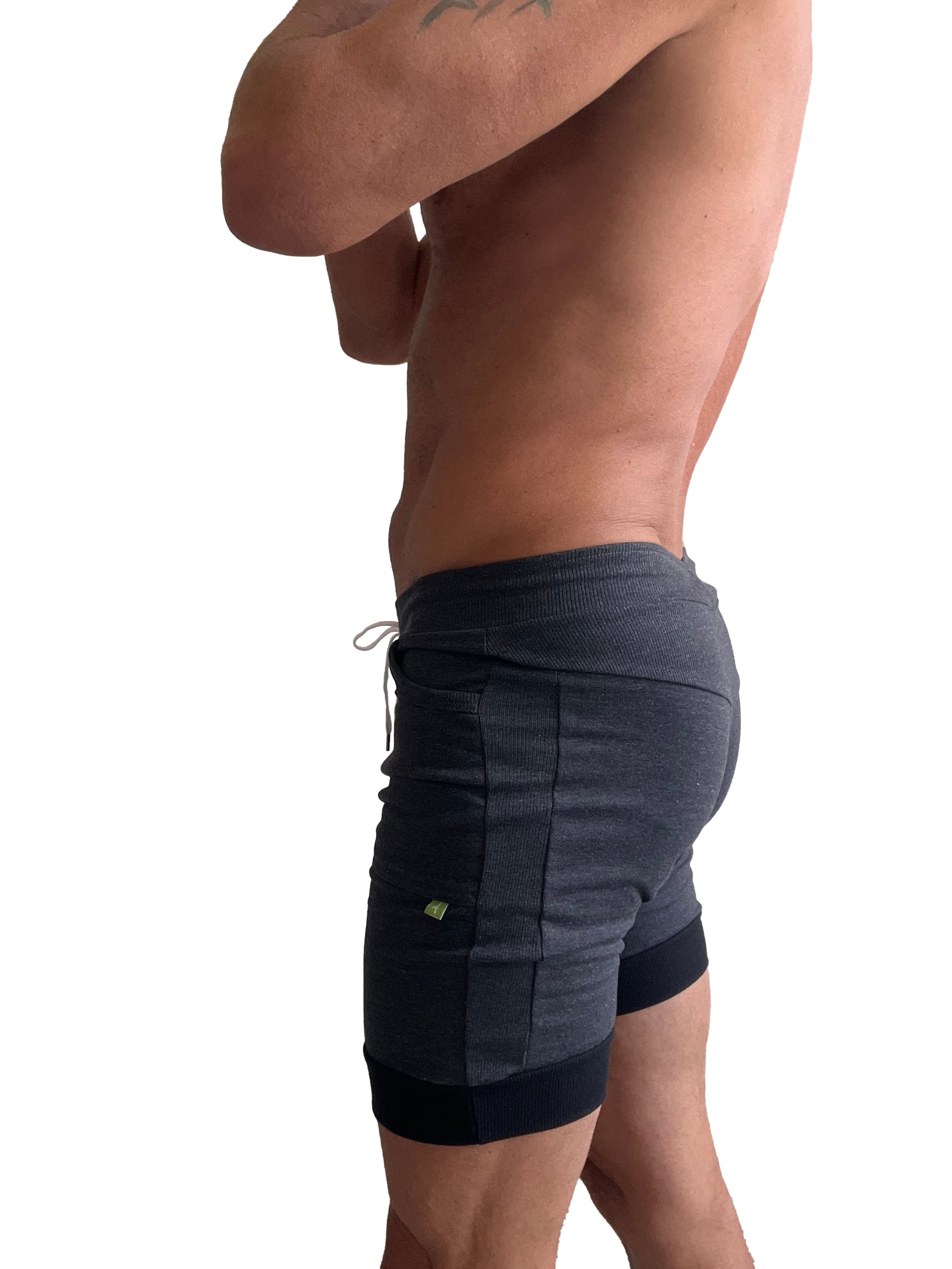 Dark gray and black two-tone cuffed yoga shorts with ribbed waistband and side pockets for athletic wear