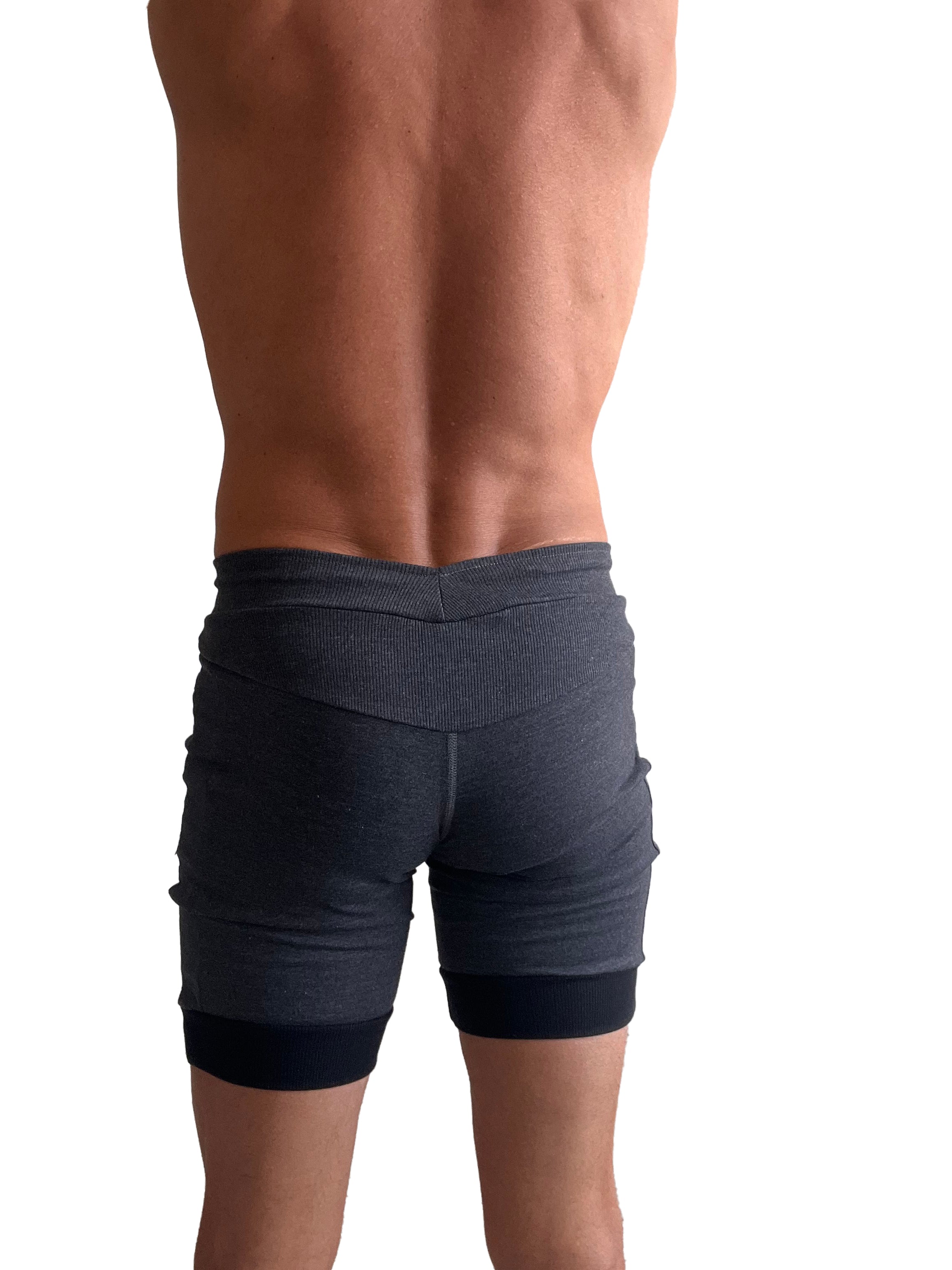 Cuffed yoga short in charcoal with black cuff featuring dark gray ribbed fabric texture and contrasting waistband and hem