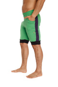 Green cuffed yoga shorts with purple side stripe and black waistband and hem trim for athletic wear
