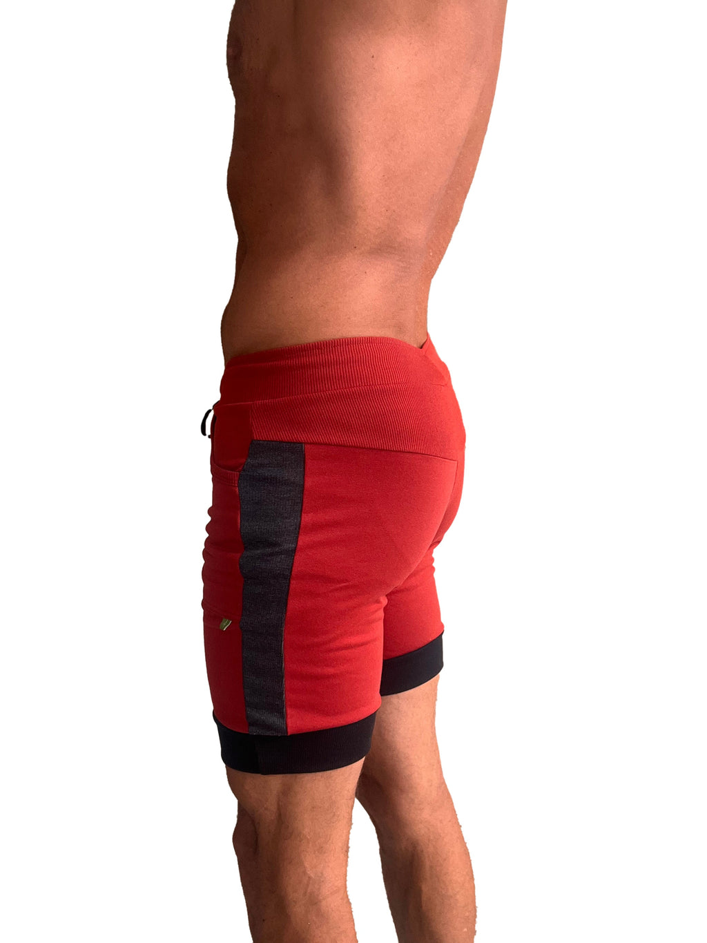 Red cuffed yoga shorts with black side panels and trim featuring a ribbed waistband for athletic wear