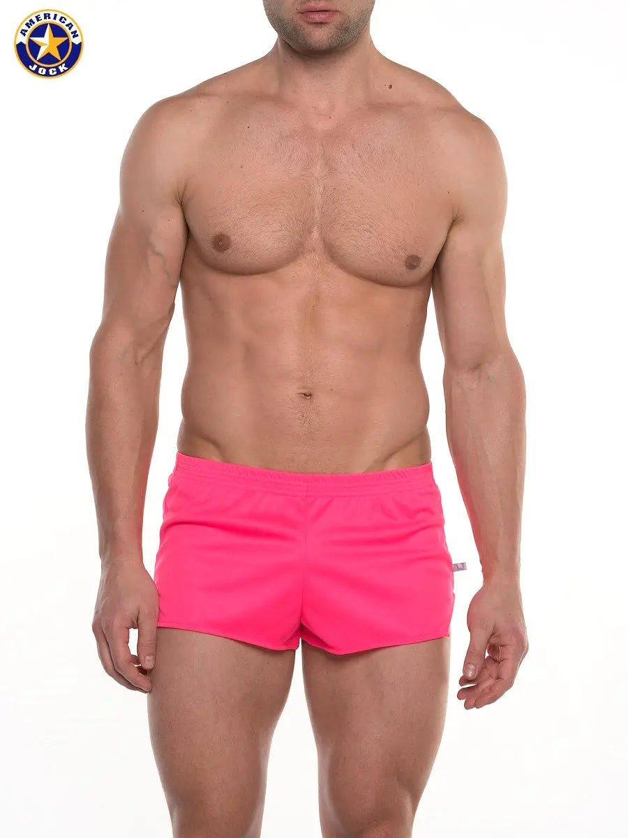 Men's pink running shorts by AMERICAN JOCK featuring a fitted design and lightweight material shown on a model.