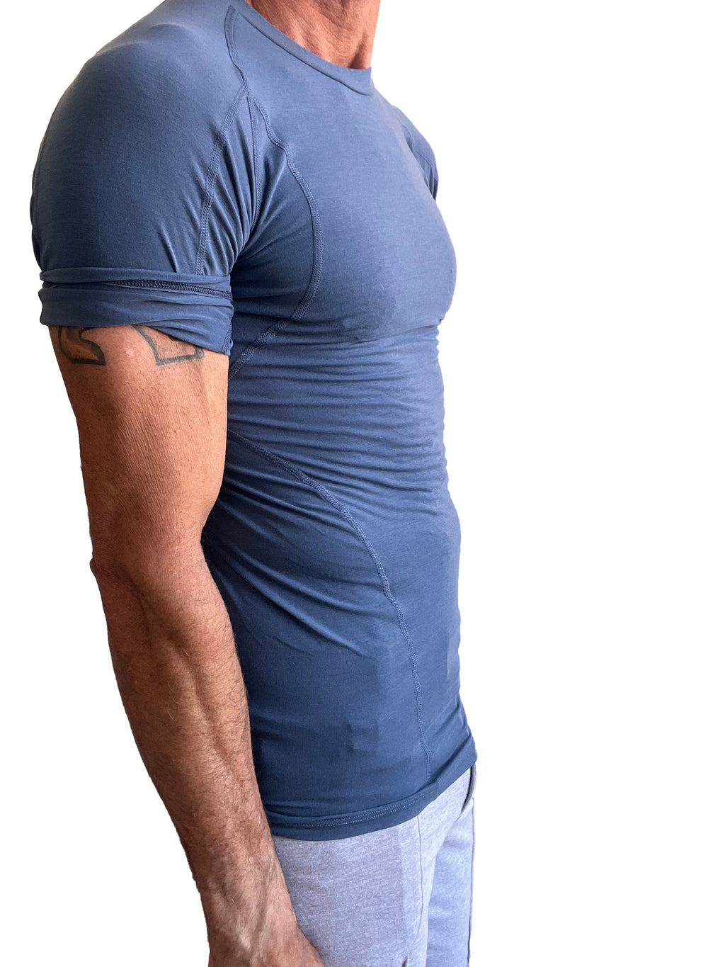 Designer raglan crew-neck tee denim blue fitted short-sleeved athletic shirt with subtle seams and rolled-up sleeves