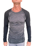 A men’s long-sleeved designer raglan crew-neck tee with heather gray torso and black fitted sleeves for active wear