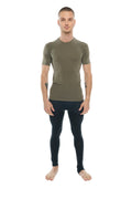 A man wearing an olive green fitted short-sleeved compression shirt paired with black leggings