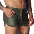 Olive green mesh athletic shorts with a drawstring waist, side pockets, and a short-cut curved hem.