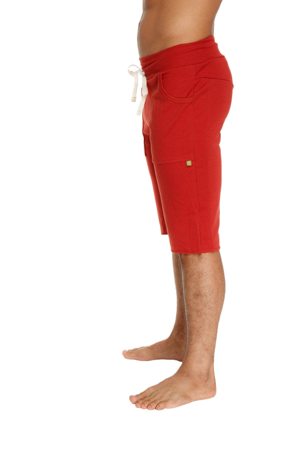 Red eco-track athletic shorts in cinnabar with white drawstring and side pockets designed for active wear