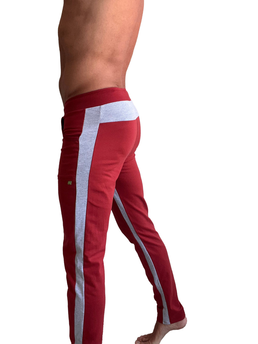 Red eco-track and yoga sweat pant with textured gray side stripe and white waistband panel in cinnabar red