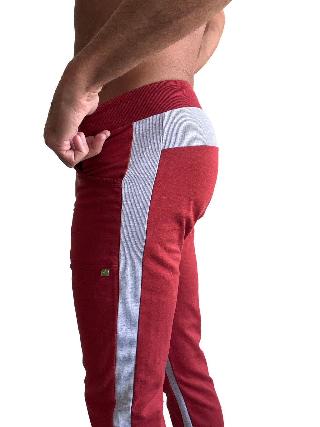 Eco-track and yoga sweat pant in cinnabar red with a vertical gray ribbed stripe and matching waistband trim
